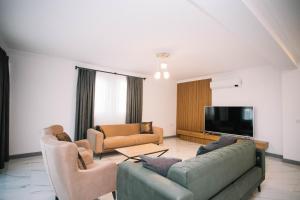 Il comprend un salon avec des canapés et une télévision à écran plat. dans l'établissement Vira Villas Premium, à Göcek