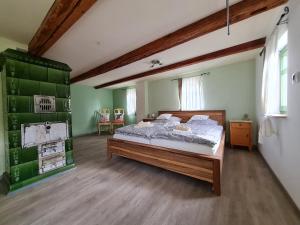 a bedroom with a large bed in a room with green walls at Unterkunft am Weinberg in Nünchritz