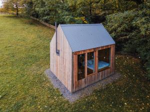 ein kleines Holzhundehaus auf einem Feld in der Unterkunft Na seně in Kozlovice