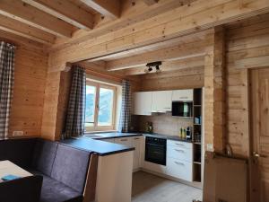 una cocina en una cabaña de madera con paredes de madera en Lipphütte Top Lage mit traumhafter Aussicht, en Rauris