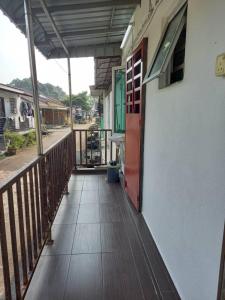 a porch of a house with a red door at Bilik Transit Nilai in Nilai