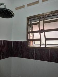 a bathroom with a window in a room at Bilik Transit Nilai in Nilai