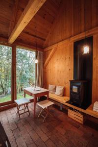 a living room with a table and a stove at Na seně in Kozlovice