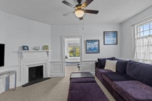 a living room with a couch and a fireplace at Spaight House Suite in New Bern