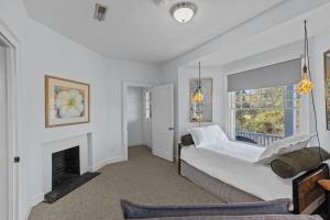 a bedroom with a bed and a fireplace at Spaight House Suite in New Bern