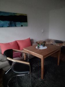 a living room with a table and a couch at FEWO Isla 1 in Elmenhorst