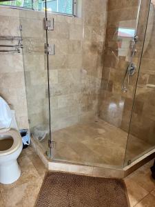 a bathroom with a shower and a toilet at Ballena Bay Villa Lot 45 Villa del Mar in Tambor