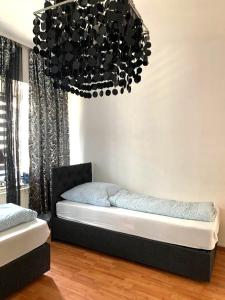 a bedroom with a bed and a chandelier at Unterkunft Mara in Oberhausen