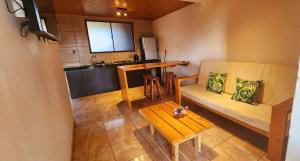a living room with a couch and a table at Apartamentos Tupuna Lodge in Hanga Roa