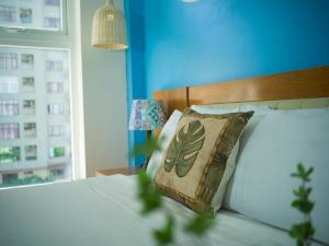 a bedroom with a bed with a pillow on it at Summer Beach Hotel Vung Tau in Vung Tau