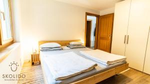1 dormitorio con 2 camas con sábanas blancas en Wohnung Gomerblick, Blitzingen, en Blitzingen