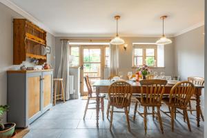 a kitchen and dining room with a table and chairs at Annie's Cottage - Big Skies Holiday Cottages in Sharrington