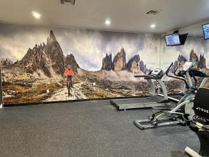 a gym with a large painting on the wall at Clarion Pointe Winslow I-40 in Winslow