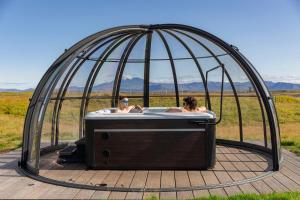 two people in a hot tub in a gazebo at Landhotel in Hella