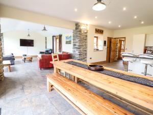 a living room with a table and a couch at The Barn in Corwen