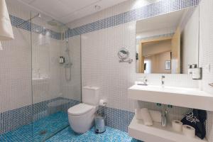 a bathroom with a toilet and a sink and a shower at Palau Apartments Valencia in Valencia