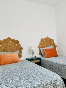 two beds sitting next to each other in a room at Apartamento con amplia terraza en la playa in Puerto del Carmen