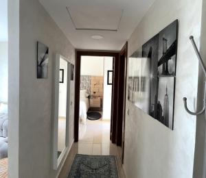 a hallway leading to a bedroom with white walls at Vague Bleue chez Makuja Home in Bouznika