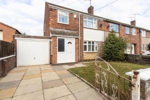 a brick house with a white garage at 3 Bedroom Home with Private Driveway in Coundon