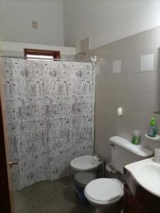 a bathroom with a toilet and a shower curtain at Casa Norte in La Rioja