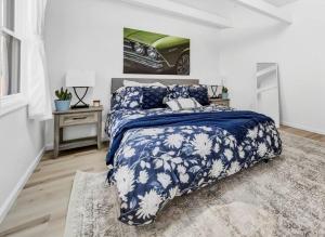 a bedroom with a bed with a blue and white comforter at Cool Urban Stay Downtown Loft in Buffalo