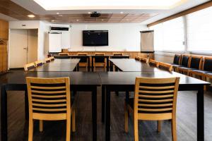 a large conference room with a large table and chairs at Hotel Logis Lacotel in Hossegor