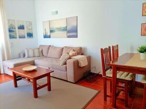 a living room with a couch and a table at Casa Perla - Cerca de la playa in Playa de Santiago