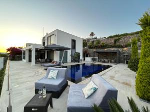 a backyard with a swimming pool and a house at Villa Aylinda with private heated Pool in Bodrum City