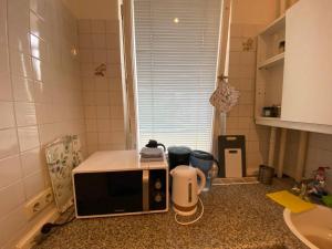 a microwave sitting on a counter in a kitchen at Modern Studio Apartment in Berlin with Garden Near Sea in Berlin