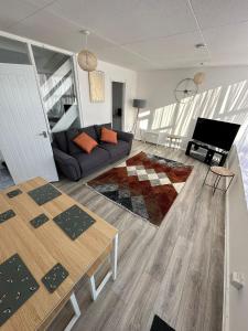 a living room with a couch and a table at Entire 3 Bedroom Apartment in Felixstowe in Felixstowe