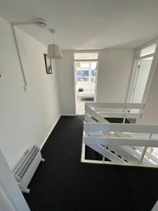 a white room with a staircase and a window at Entire 3 Bedroom Apartment in Felixstowe in Felixstowe