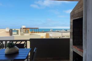 a vase sitting on a table on a balcony at Dolphin View 20 @ LongBeach in Langstrand