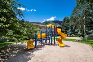 a playground in a park with yellow and blue equipment at Best Western Antlers at Glenwood Springs in Glenwood Springs