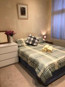 a bedroom with a bed with two pillows on it at Great Apartman Liverpool in Liverpool