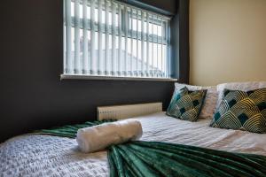 a bed sitting under a window in a bedroom at The Good night rooms liverpool 