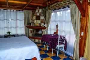 a bedroom with a bed and a table and chairs at Tu Casa - Hotel Rural in Sopó +67 photos