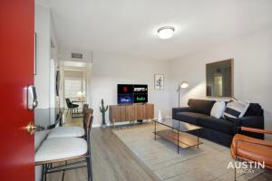 a living room with a couch and a table at Spacious 2 Apt Combo Sleeps 12 Pool and Pets in Austin