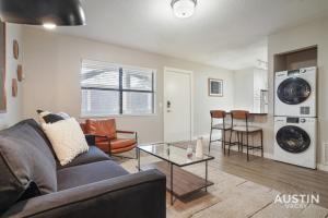 a living room with a couch and a table at Spacious 2 Apt Combo Sleeps 12 Pool and Pets in Austin