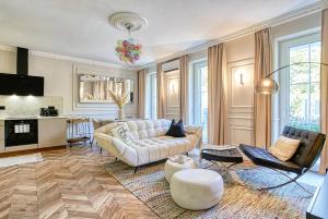 a living room with a couch and a table at The Doors Luxury Apartment in Mosonmagyaróvár