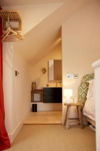 an attic bedroom with a bed and a table at The Old Winery Cottage No1 in Shepton Mallet