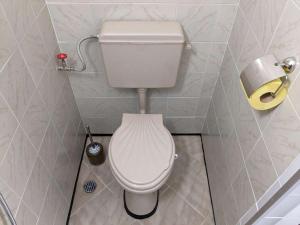 a bathroom with a toilet in a small room at Lazur Apartment in Burgas