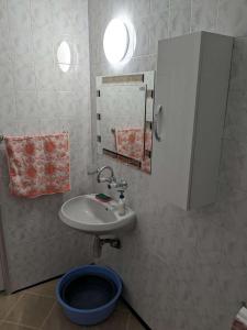 a bathroom with a toilet and a sink and a mirror at Lazur Apartment in Burgas