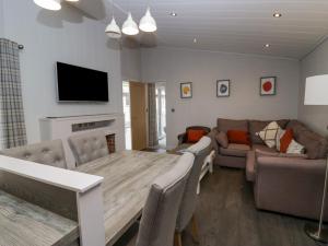 - un salon avec une table et un canapé dans l'établissement The Bothy, à Keswick