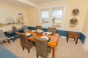 a dining room with a table and chairs at Shoreline Cottage - Oceanfront - North End VB in Virginia Beach