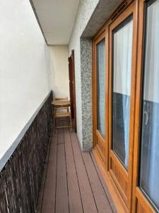 a balcony with a wooden floor and a window at T3 Horizon- Face Gare -18 Min Paris in Villemomble