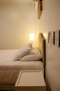 מיטה או מיטות בחדר ב-Suítes Casa Aurora