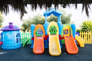 a playground with a slide in a park at Grand Hotel Selinunte in Marinella di Selinunte