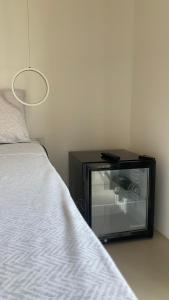 a bedroom with a tv next to a bed at Habitación en suite in Fernando de la Mora