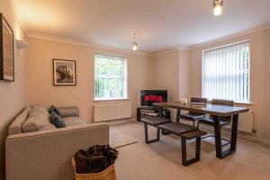 a living room with a table and a couch at Spacious Apartment Near Birmingham Centre and NeC in Birmingham