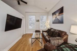 a living room with a couch and a table at 2-Bed 2-Bath Apt - Close to UC w/ Free Parking in Chicago